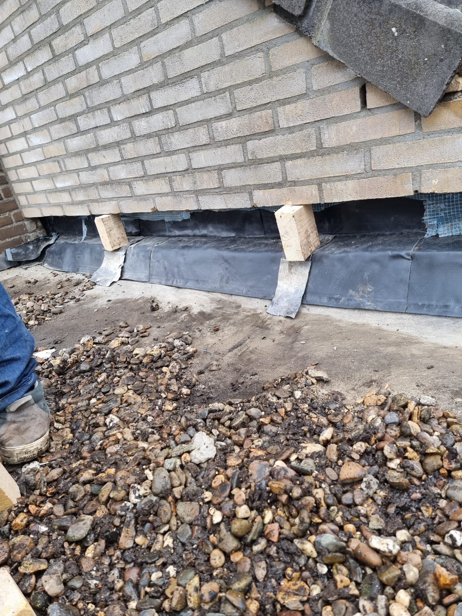 Constructief herstel aan onderzijde van bakstenen gevel met open metselwerk Constructief herstel aan bakstenen gevel met open metselwerk