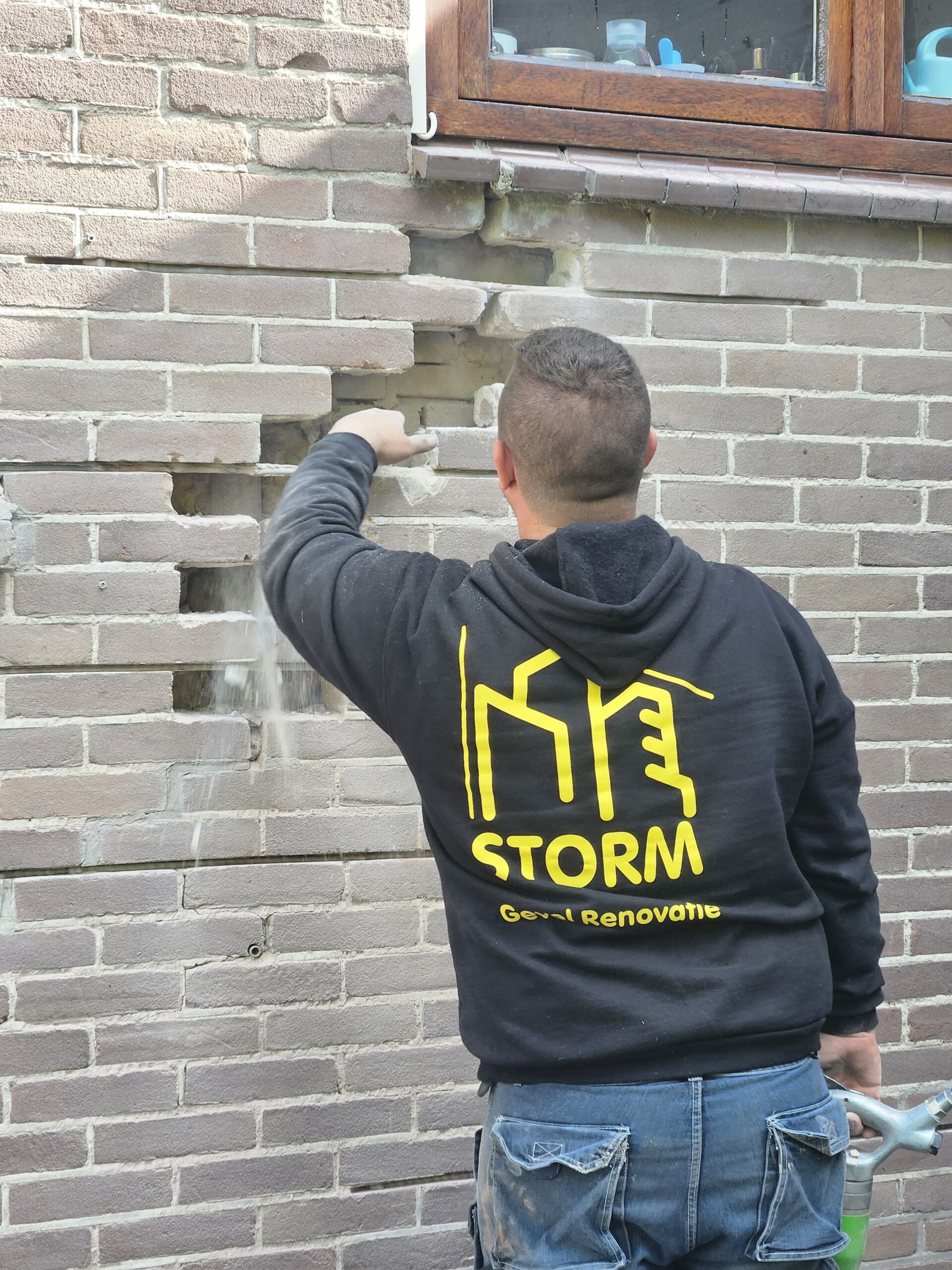 Vakman voert voegwerkherstel uit aan lichte bakstenen gevel onder houten kozijn Voegwerk vervangen en gevelherstel in Westland